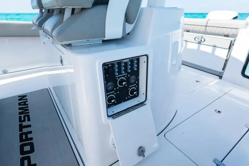 Slide: The Image of 2026 Sportsman Open 302 Center Console boat interior with control panel and seating. - 16