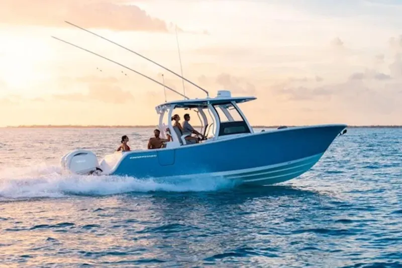 Slide: The Image of 2026 Sportsman Open 302 Center Console boat cruising on ocean at sunset. - 2