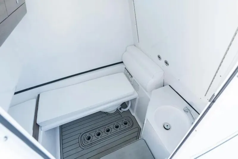 Slide: The Image of 2026 Sportsman Open 302 Center Console interior with seating and sink. - 6