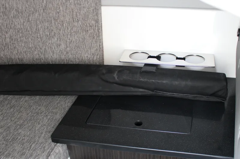 Slide: The Image of 2025 Cobalt R33 interior with cup holders and black accessory on a textured surface. - 22