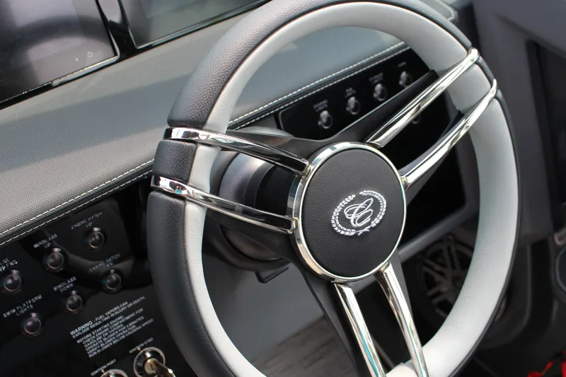 Slide: The Image of Steering wheel of 2025 Cobalt R33 boat with sleek design and control panel. - 23