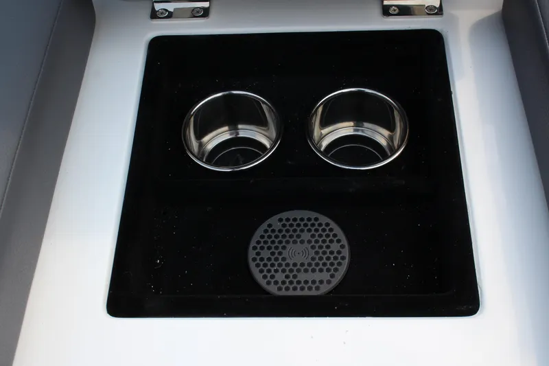 Slide: The Image of 2025 Cobalt R33 cup holders and wireless charging pad in black console. - 24