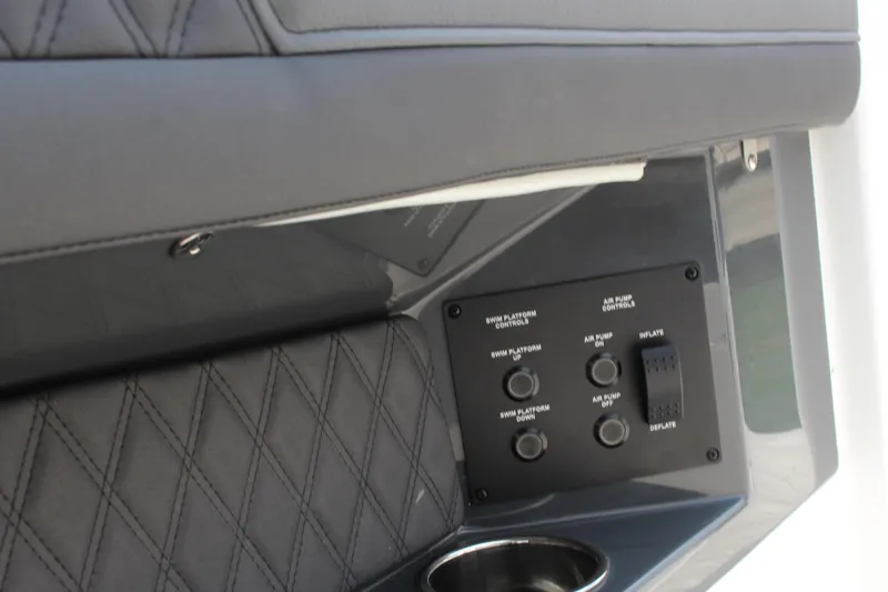 Slide: The Image of Control panel in 2025 Cobalt R33 with quilted upholstery and cup holder. - 27