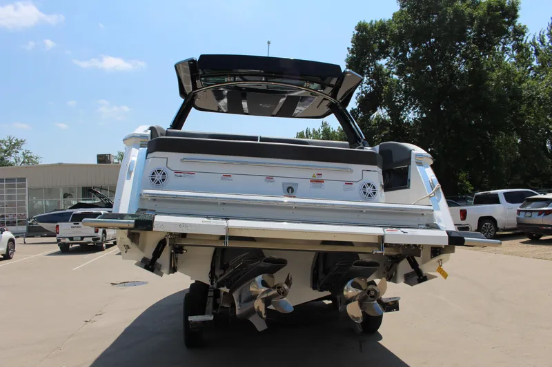 Slide: The Image of 2025 Cobalt R33 boat rear view, showcasing dual propellers and sleek design in a parking lot. - 41