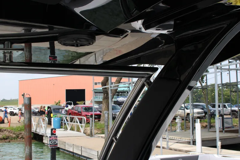 Slide: The Image of 2025 Cobalt R33 boat interior with dockside view and parked vehicles. - 45
