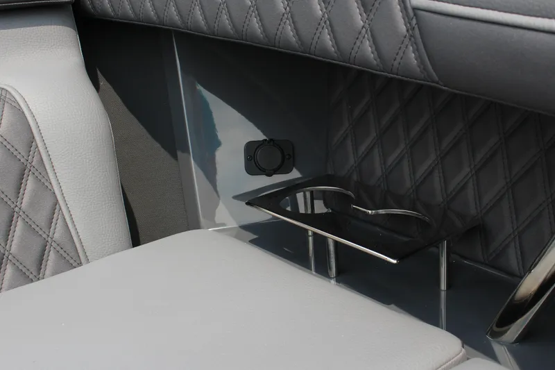 Slide: The Image of 2025 Cobalt R33 interior with quilted leather and cup holder detail. - 47