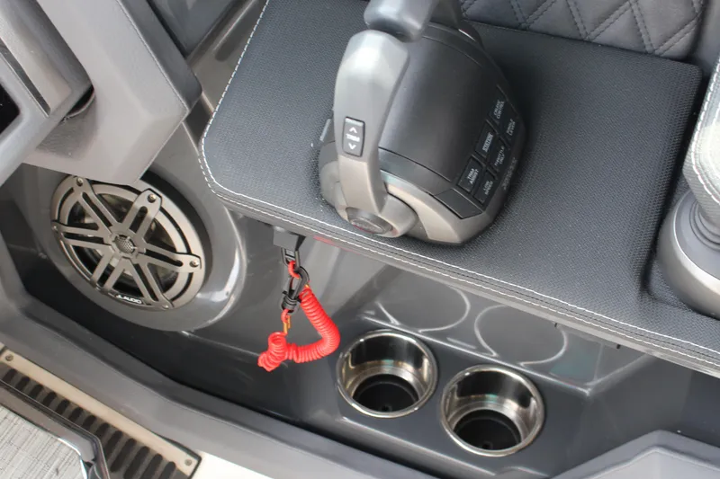 Slide: The Image of 2025 Cobalt R33 boat interior with control panel, speaker, and cup holders. - 7