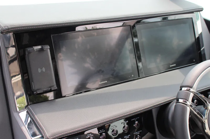 Slide: The Image of 2025 Cobalt R33 dashboard featuring dual Garmin screens and wireless charging pad. - 8
