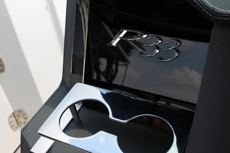 Slide: The Image of 2025 Cobalt R33 interior detail with chrome cup holder and logo. - 9
