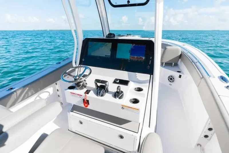 Slide: The Image of 2026 Sportsman Open 282 boat interior with modern dashboard and ocean view. - 12