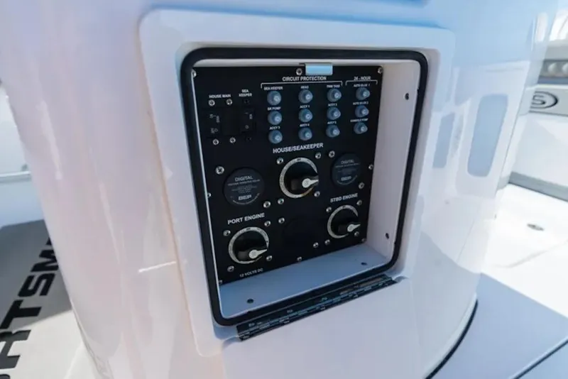 Slide: The Image of Control panel on a 2026 Sportsman Open 282 boat, featuring circuit protection switches. - 9