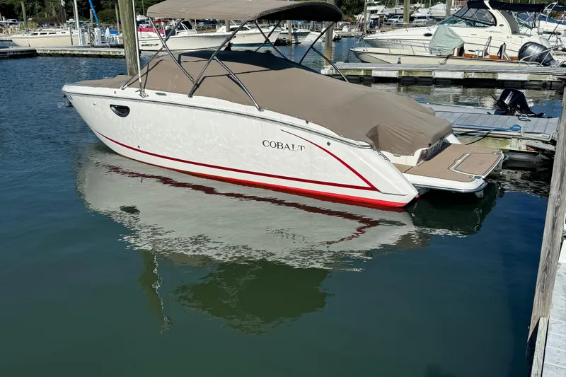 The Image of 2014 Cobalt R5 boat docked in marina, covered with beige canopy. - 0