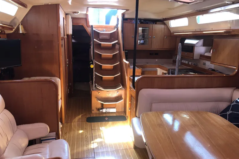 Slide: The Image of Interior of a 2000 Catalina 470 yacht with wooden furnishings and cozy seating. - 13