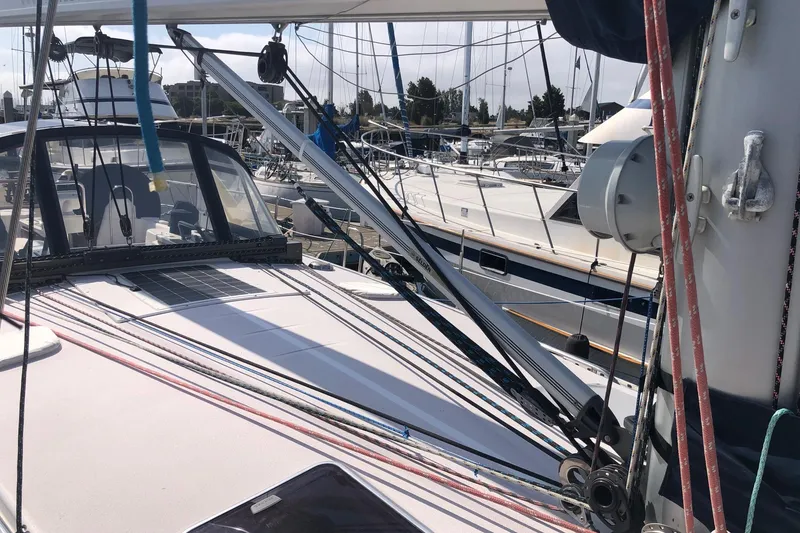 Slide: The Image of Sailboat deck view of 2000 Catalina 470 in marina, showcasing rigging and cockpit. - 16
