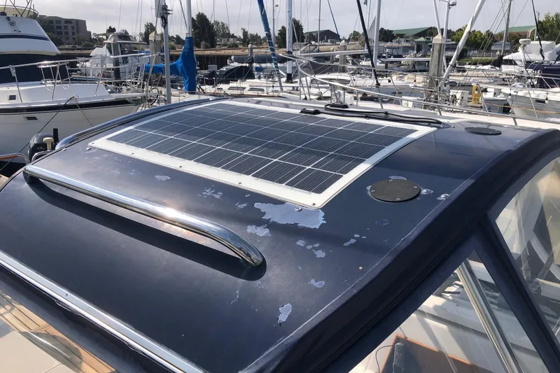 Slide: The Image of Catalina 470 yacht (2000) with solar panel on deck, docked at marina. - 18