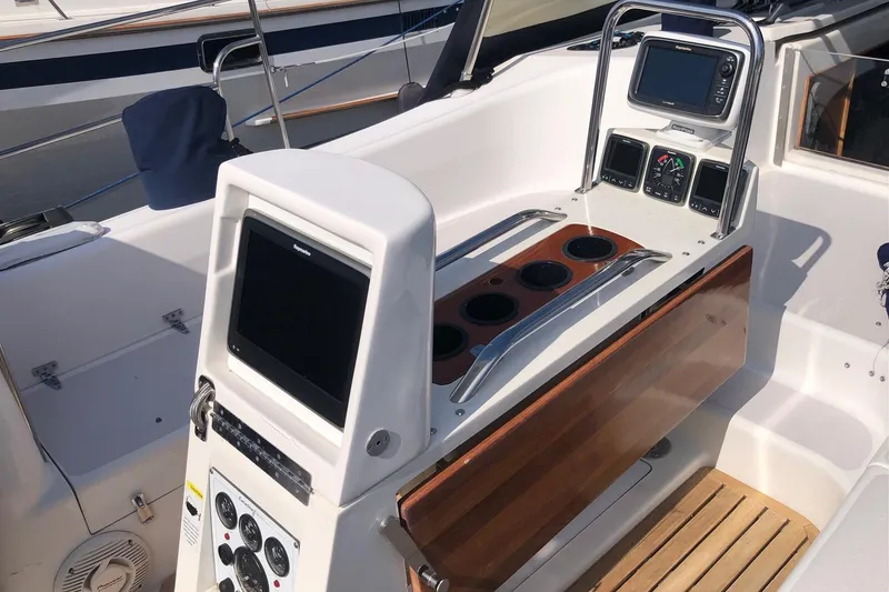Slide: The Image of Cockpit of 2000 Catalina 470 sailboat with navigation instruments and wooden accents. - 19