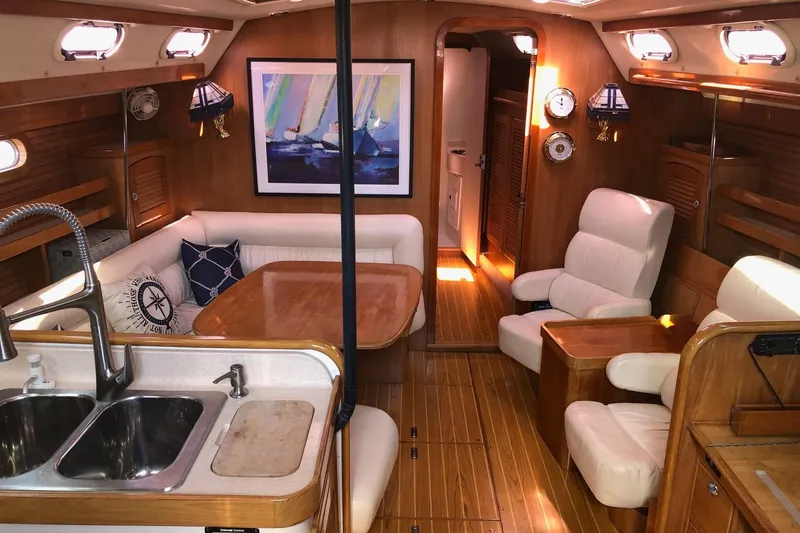 Slide: The Image of Interior of a 2000 Catalina 470 yacht with wooden furnishings and cozy seating. - 2