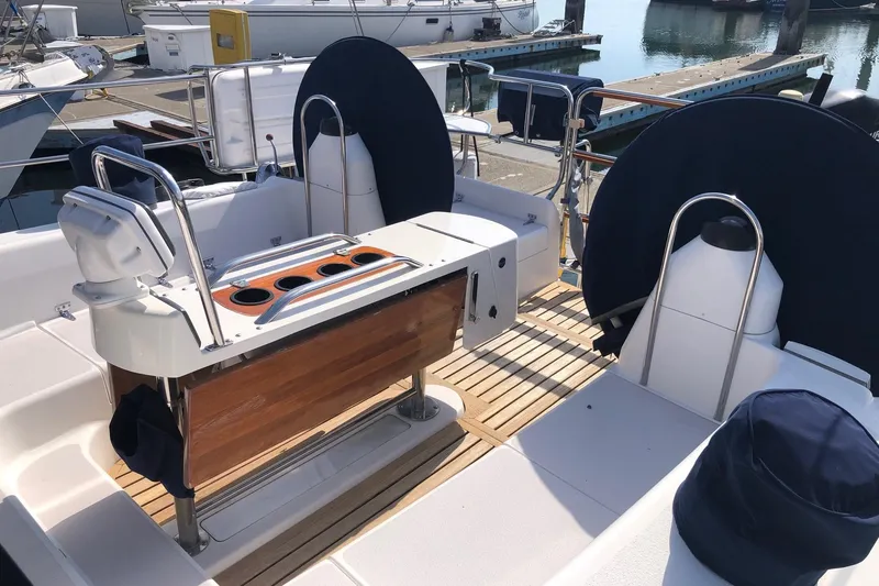 Slide: The Image of Cockpit of a 2000 Catalina 470 sailboat with dual steering wheels and wooden accents. - 22