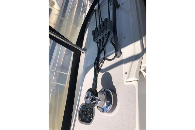 Slide: The Image of Sailing rigging on a 2000 Catalina 470 yacht deck, featuring winch and cleats. - 24