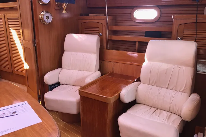 Slide: The Image of Interior of 2000 Catalina 470 yacht with plush seating and wooden finishes. - 4