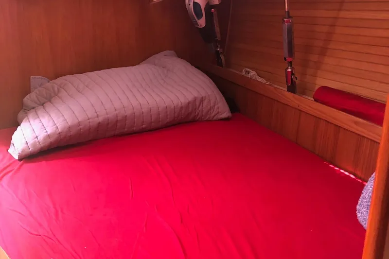 Slide: The Image of Cozy cabin bed with red bedding in 2000 Catalina 470 sailboat. - 7