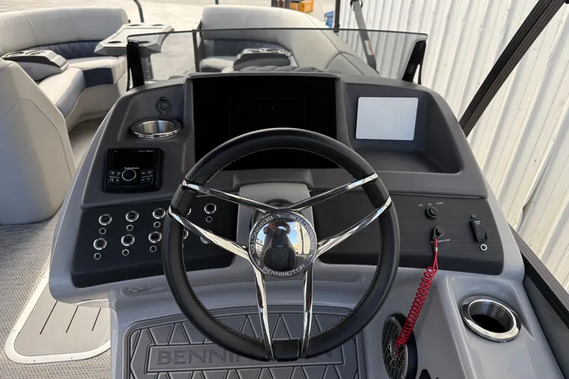 Slide: The Image of 2024 Bennington 23 RSB boat dashboard with steering wheel and control panel. - 13
