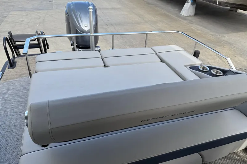 Slide: The Image of 2024 Bennington 23 RSB boat with cushioned seating and cup holders, featuring a sleek design. - 16