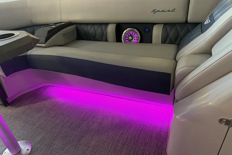 Slide: The Image of 2024 Bennington 23 RSB interior with purple LED lighting and luxurious seating. - 25