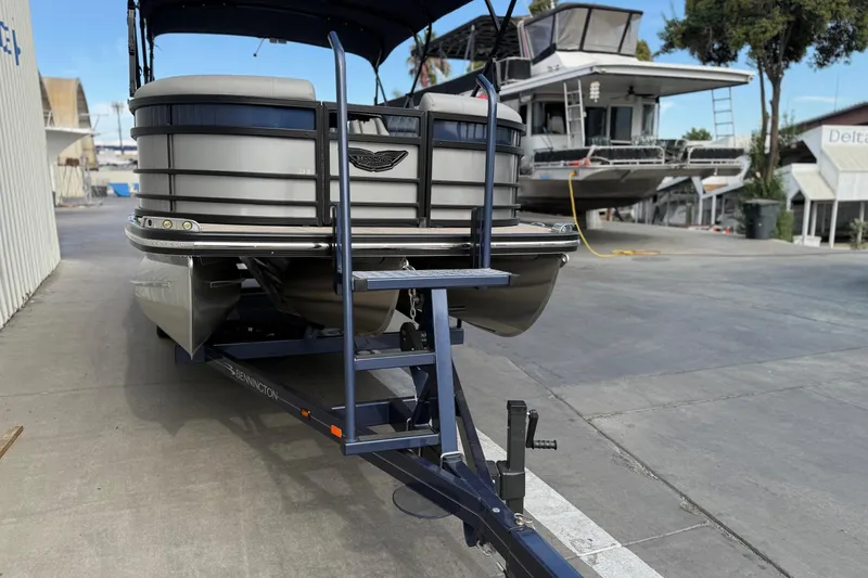 Slide: The Image of 2024 Bennington 23 RSB pontoon boat on trailer at marina. - 3