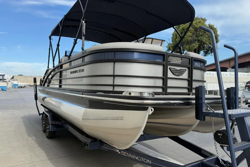 Slide: The Image of 2024 Bennington 23 RSB pontoon boat on trailer, featuring sleek design and canopy. - 4