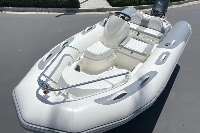 Slide: The Image of 2007 Zodiac Yachtline Deluxe 420 inflatable boat with white seating and sleek design. - 11