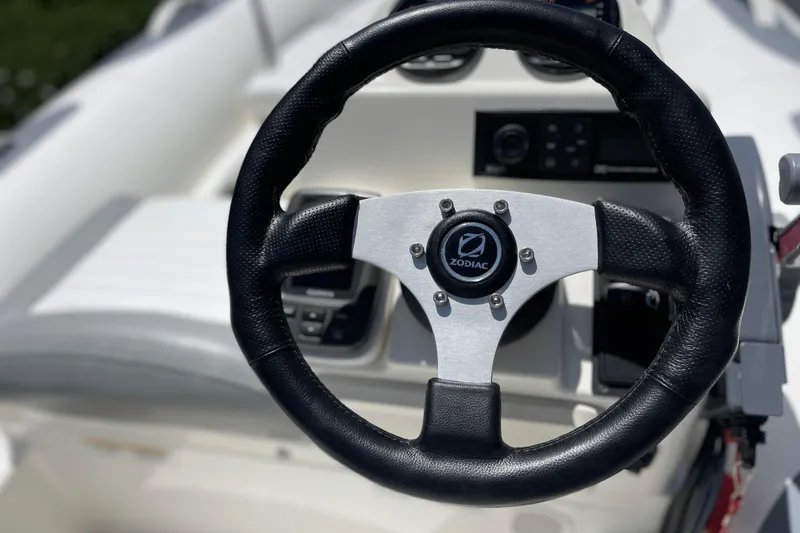 Slide: The Image of Steering wheel of 2007 Zodiac Yachtline Deluxe 420 boat, featuring sleek design and controls. - 4
