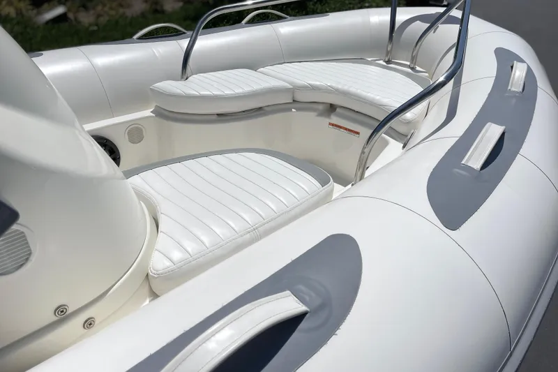 Slide: The Image of 2007 Zodiac Yachtline Deluxe 420 boat interior with white cushioned seating and sleek design. - 6