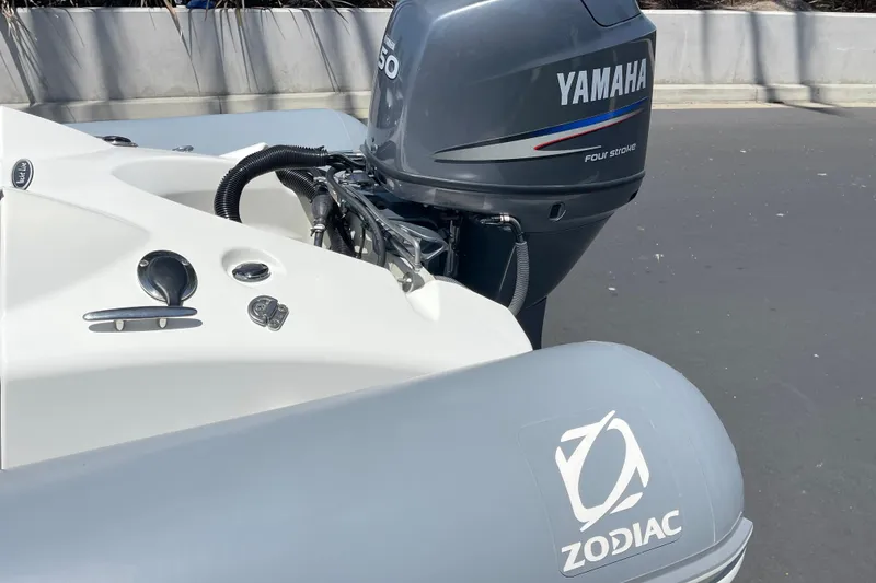 Slide: The Image of 2007 Zodiac Yachtline Deluxe 420 with Yamaha outboard motor, docked on a sunny day. - 9