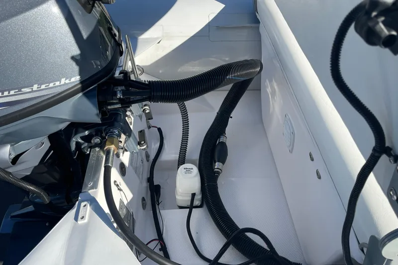 Slide: The Image of 2020 Achilles HB-315DX boat engine compartment with hoses and components. - 14
