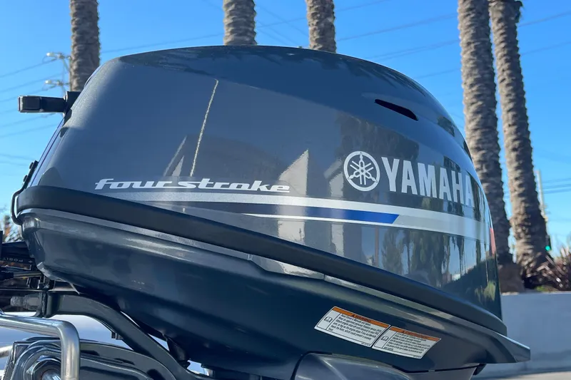 Slide: The Image of Yamaha four-stroke outboard motor against a backdrop of palm trees and blue sky. - 16