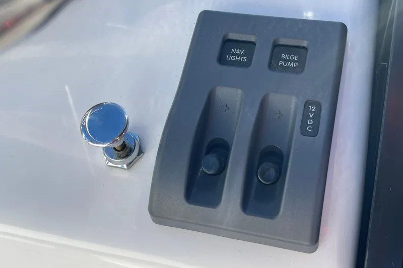 Slide: The Image of Control panel of 2020 Achilles HB-315DX with navigation lights and bilge pump switches. - 21