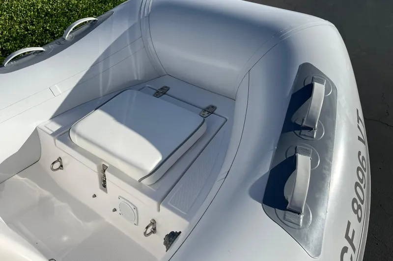 Slide: The Image of 2020 Achilles HB-315DX inflatable boat interior with storage compartment and handles. - 3