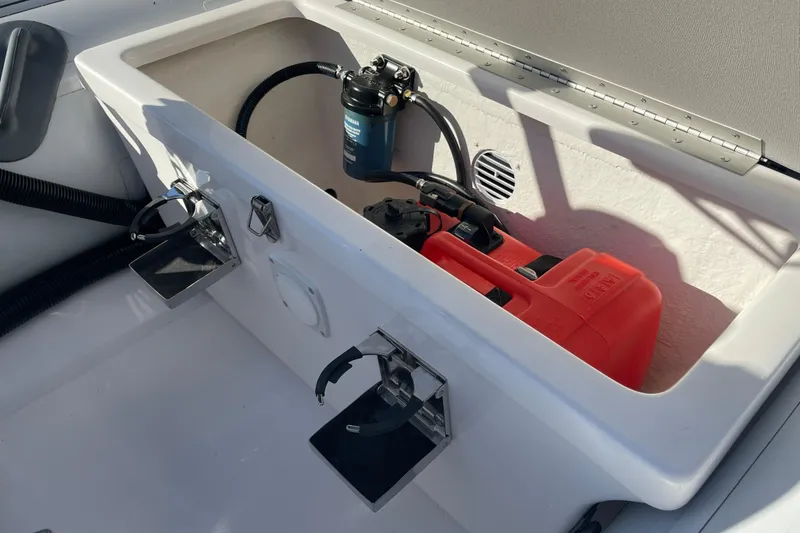 Slide: The Image of Storage compartment in a 2020 Achilles HB-315DX boat with fuel tank and pump. - 5