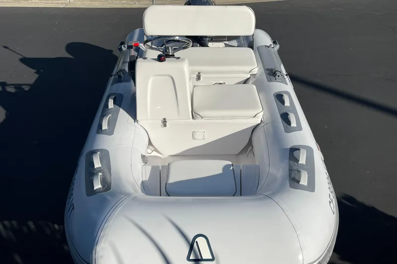 Slide: The Image of 2020 Achilles HB-315DX inflatable boat with white seating and steering console. - 8