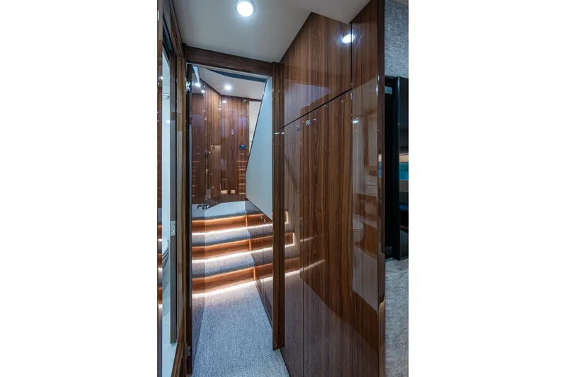 Slide: The Image of Luxurious interior hallway of 2023 Maritimo M55 yacht with wood paneling and ambient lighting. - 103