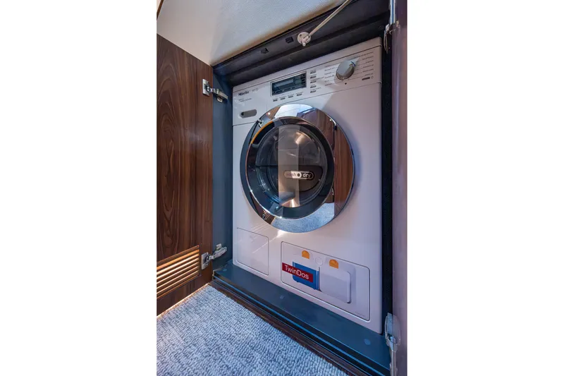 Slide: The Image of 2023 Maritimo M55 yacht interior with built-in washer-dryer unit. - 104