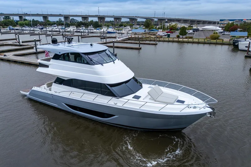 Slide: The Image of 2023 Maritimo M55 yacht docked in marina, showcasing sleek design and modern features. - 11