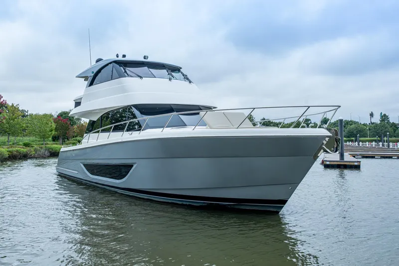 Slide: The Image of 2023 Maritimo M55 yacht docked on calm water, showcasing sleek design and modern features. - 110