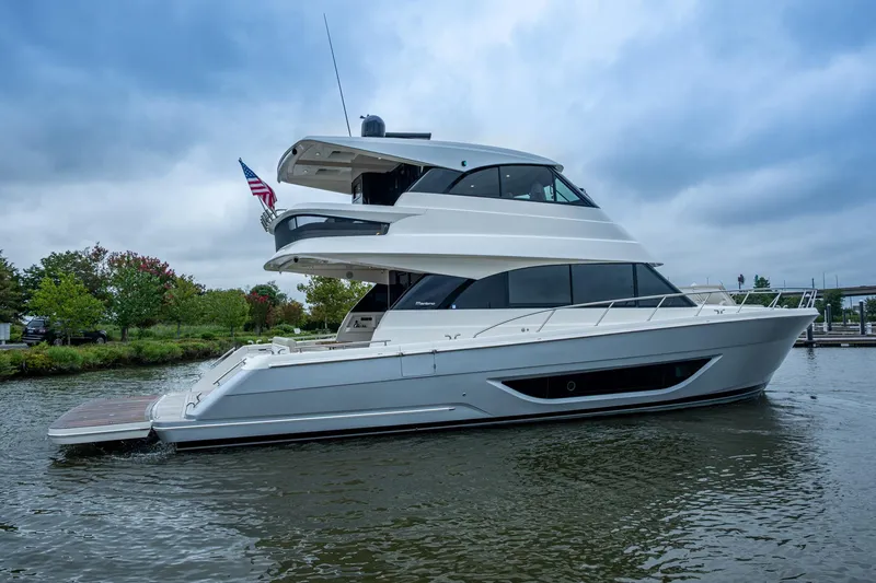 Slide: The Image of 2023 Maritimo M55 yacht on water, sleek design, overcast sky. - 115