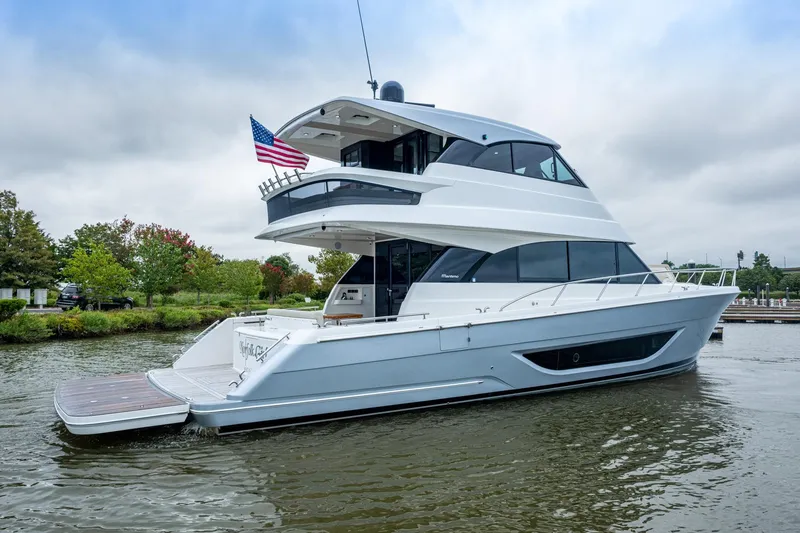 Slide: The Image of 2023 Maritimo M55 yacht on water, featuring sleek design and American flag. - 116