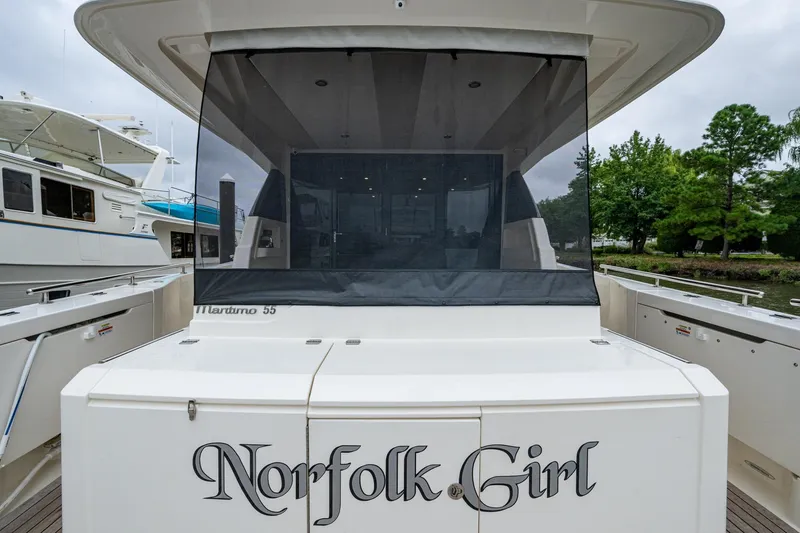 Slide: The Image of 2023 Maritimo M55 yacht "Norfolk Girl" docked, rear view with covered deck. - 127