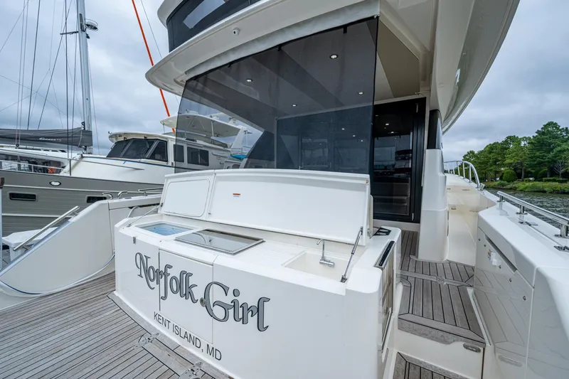 Slide: The Image of 2023 Maritimo M55 yacht docked, featuring spacious deck and sleek design. - 130