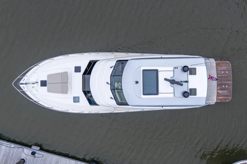 Slide: The Image of Aerial view of 2023 Maritimo M55 yacht on water, showcasing sleek design and spacious deck. - 14