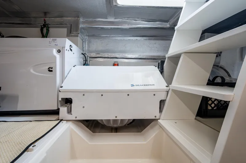 Slide: The Image of Engine room of 2023 Maritimo M55 yacht featuring Seakeeper stabilizer system. - 144